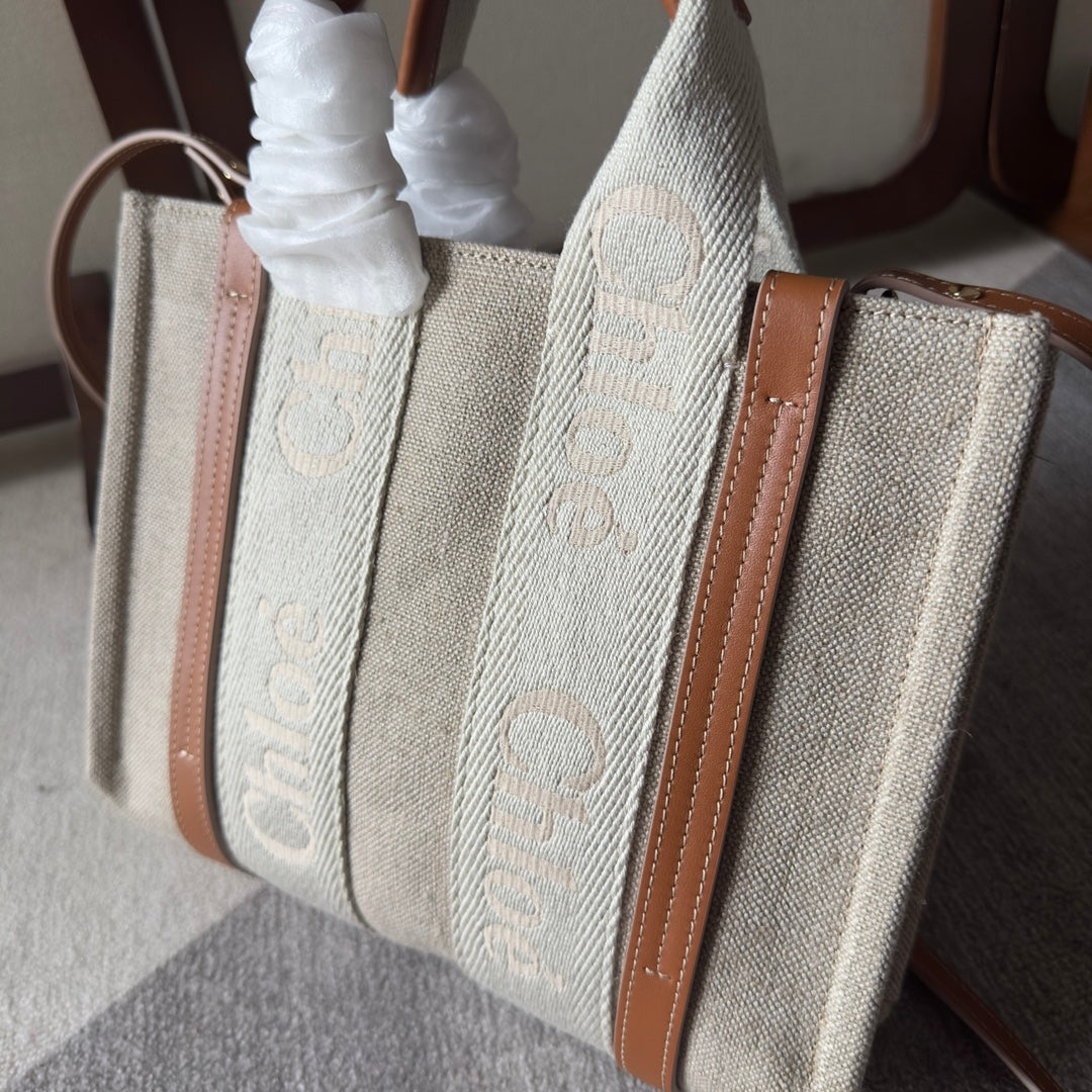 SMALL WOODY TOTE BAG 26.5 IN BEIGE LINEN CANVAS WEBBING LOGO EMBROIDERY BROWN CALFSKIN