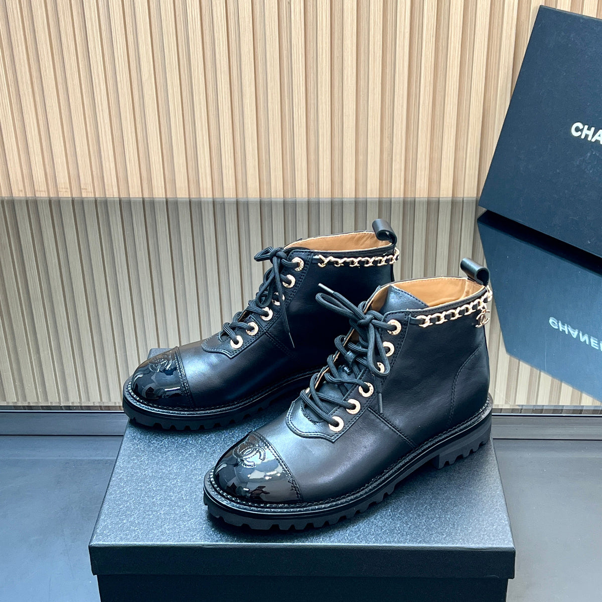 CHANEL 25S MARTIN LACE-UP BOOTS WITH CHAIN DETAIL IN BLACK CALFSKIN