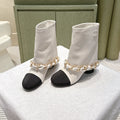 CHANEL 25S CALF-LENGTH BOOTS 45MM IN WHITE AND BLACK CALFSKIN GOLD HARDWARE